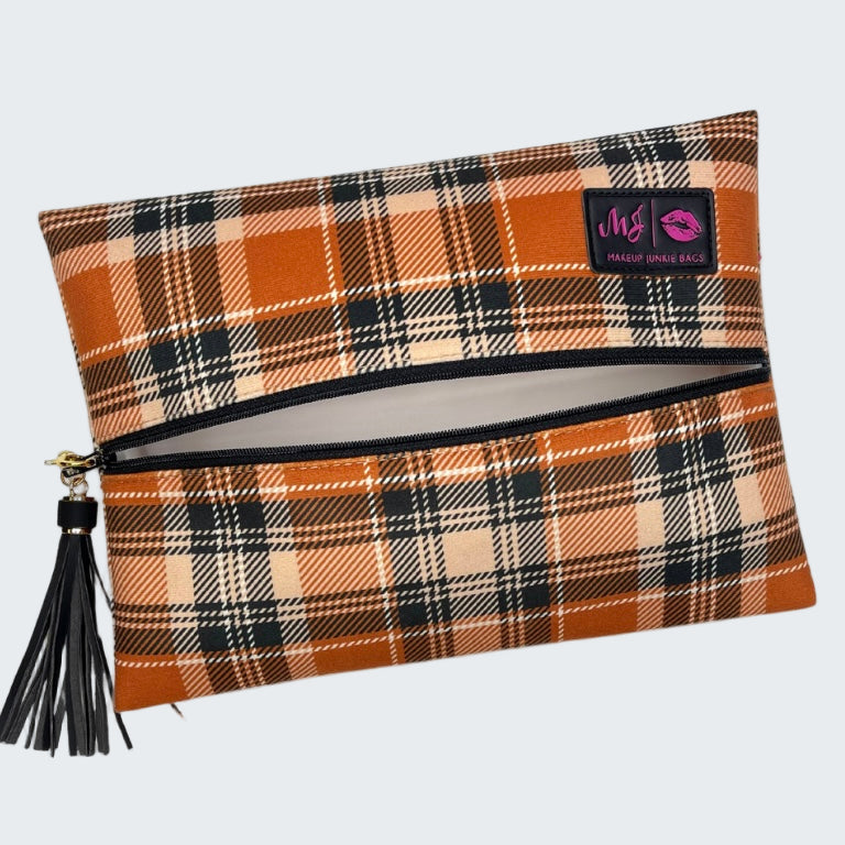 Plaid patterned pouch with a tassel on a white background