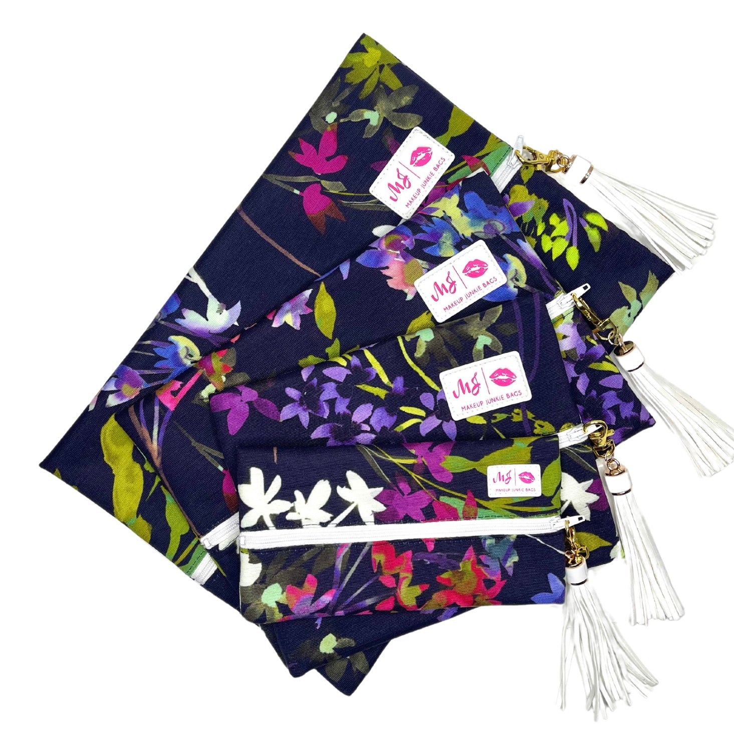Navy blue bags with colorful floral patterns and white tassels on a white background
