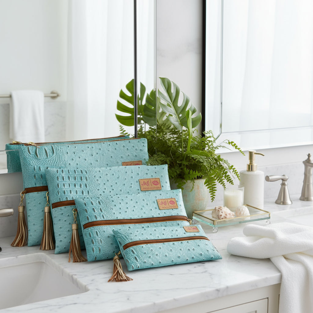 Set of turquoise bags with brown accents and tassels on a white background