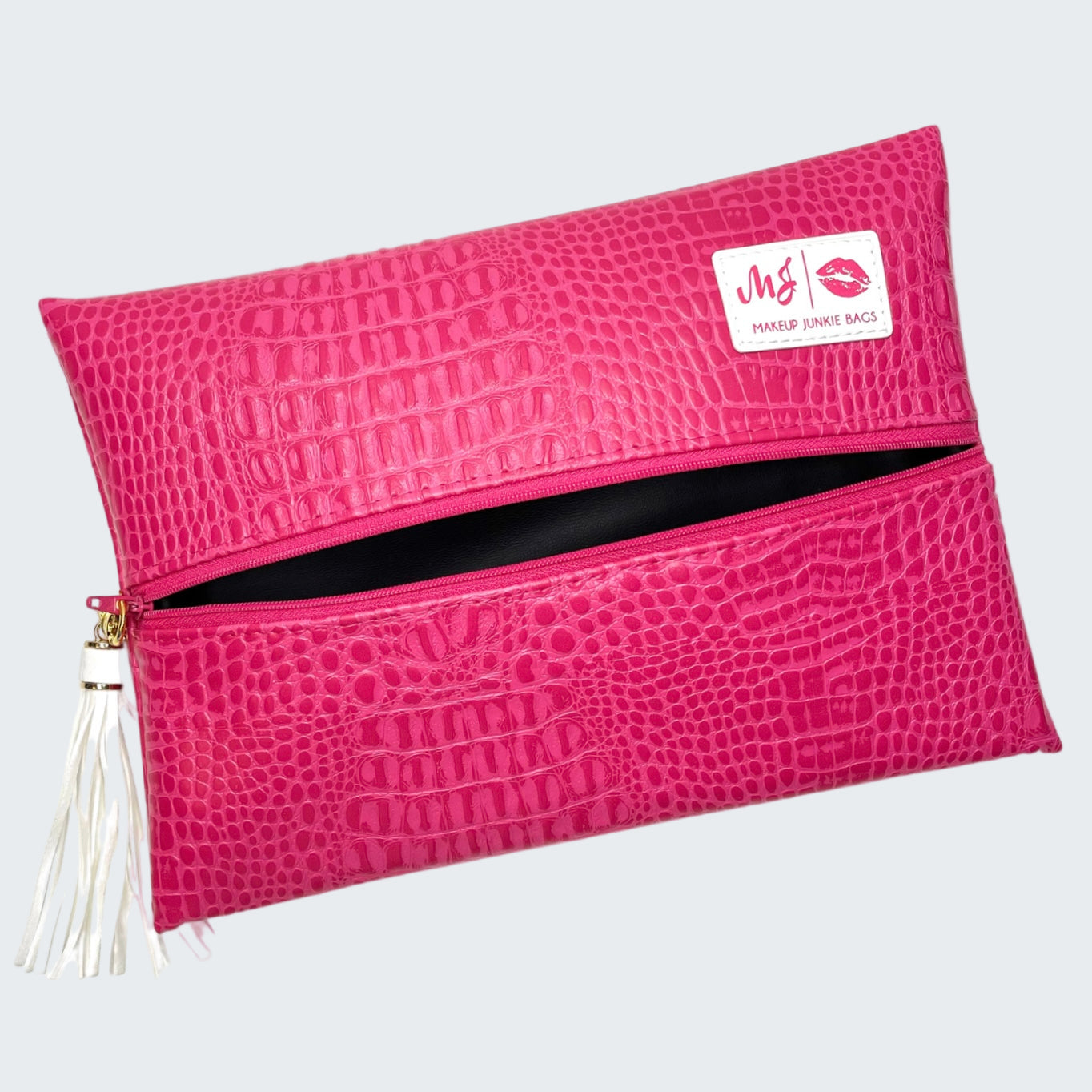 Pink crocodile-patterned pouch with a visible brand label on a white background