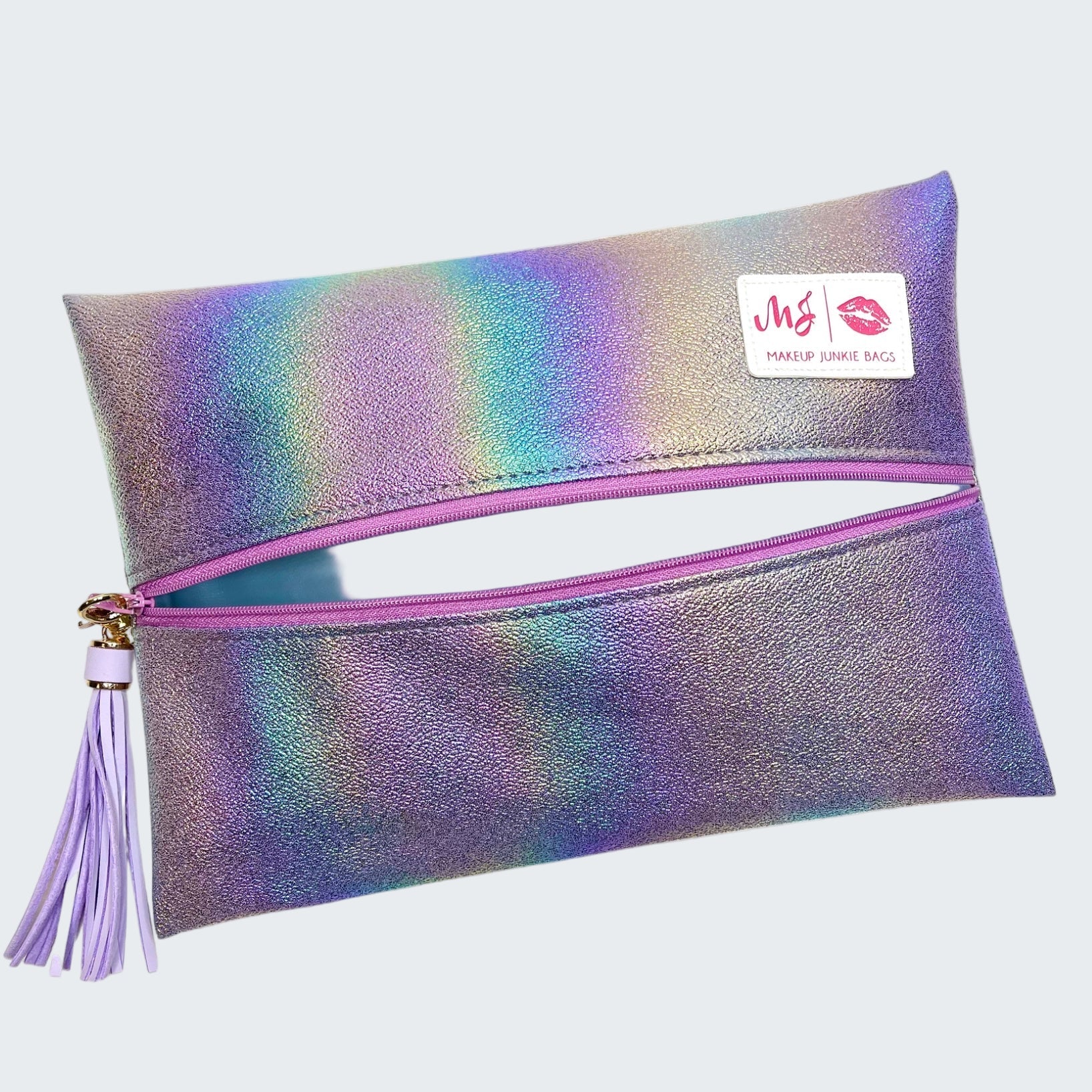 Iridescent makeup bag with pink zipper and tassel on a white background