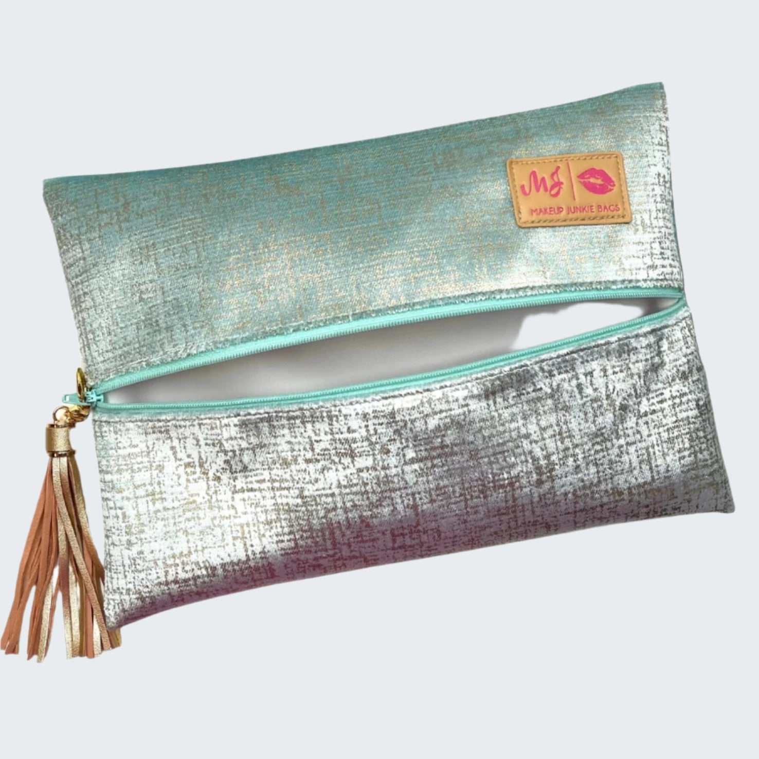 Metallic clutch bag with a tassel on a white background