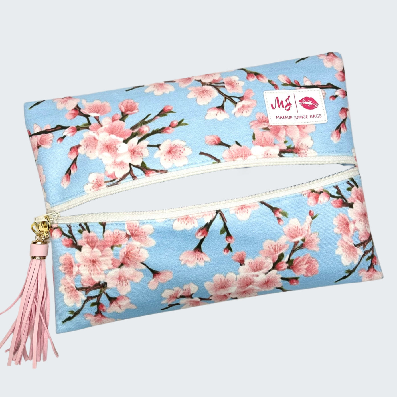 Makeup bag with cherry blossom design on a white background