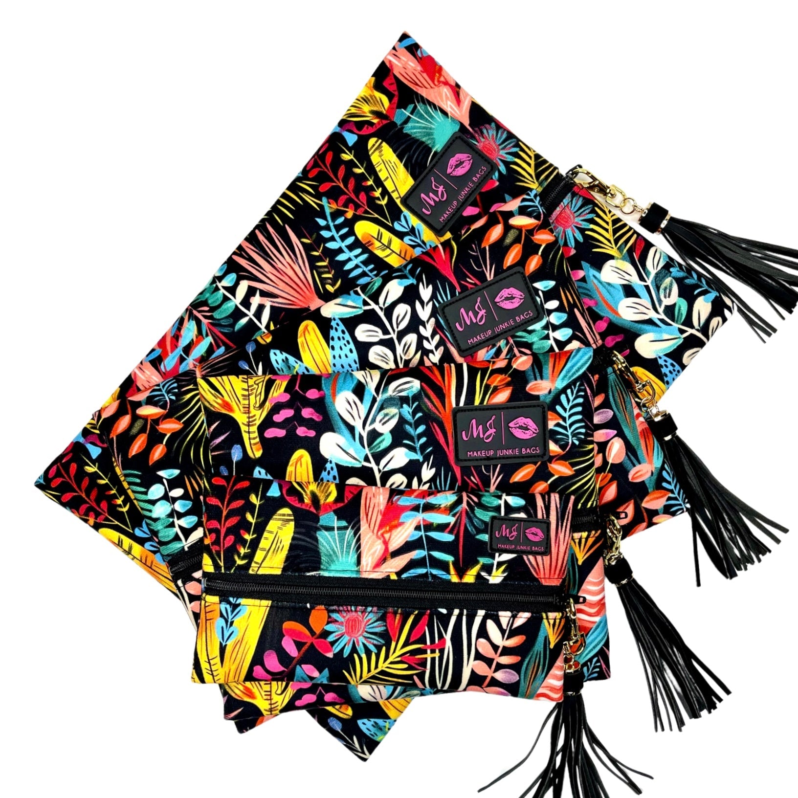 Colorful makeup bags with floral patterns and black tassels on a white background