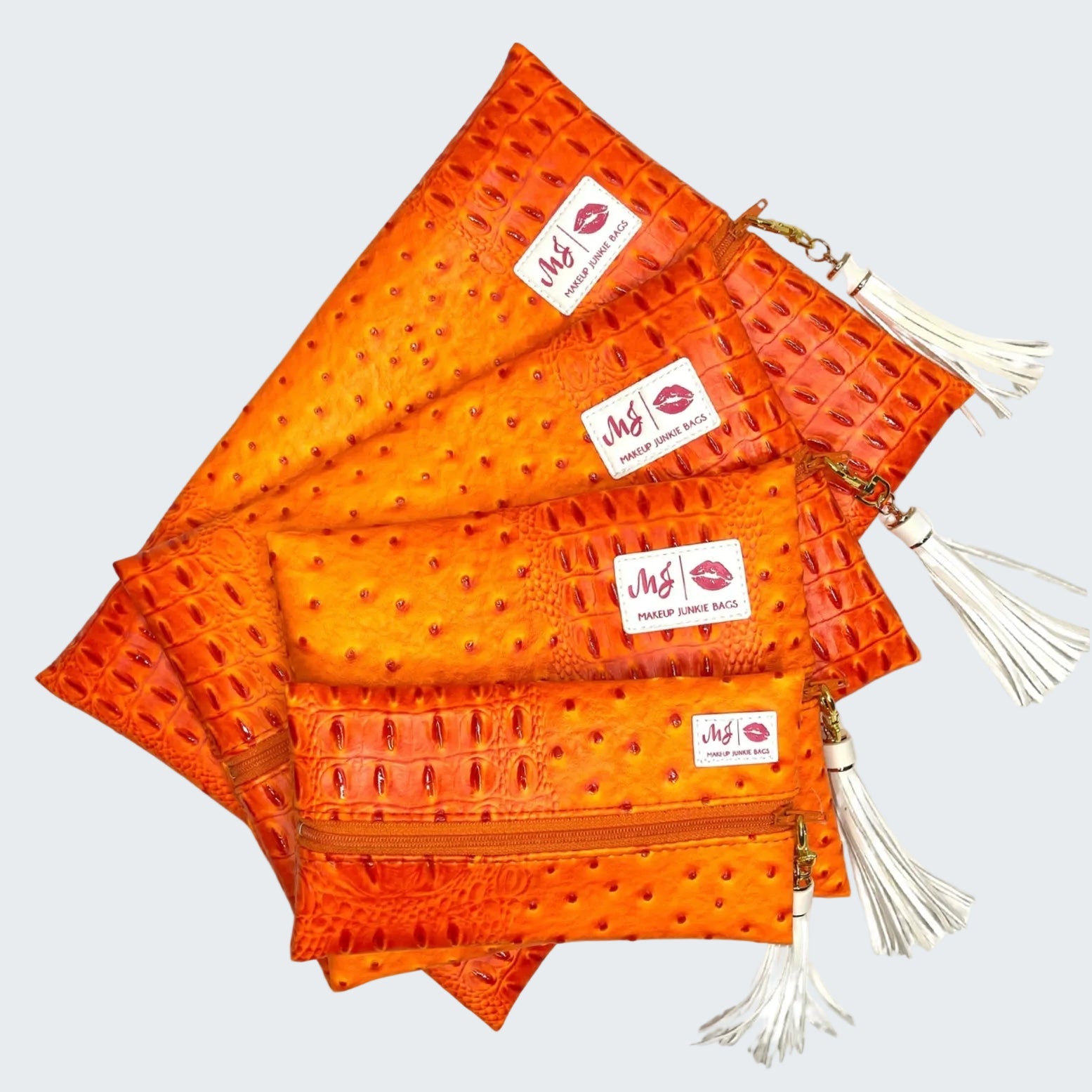 Stack of orange bags with visible branding on a white background