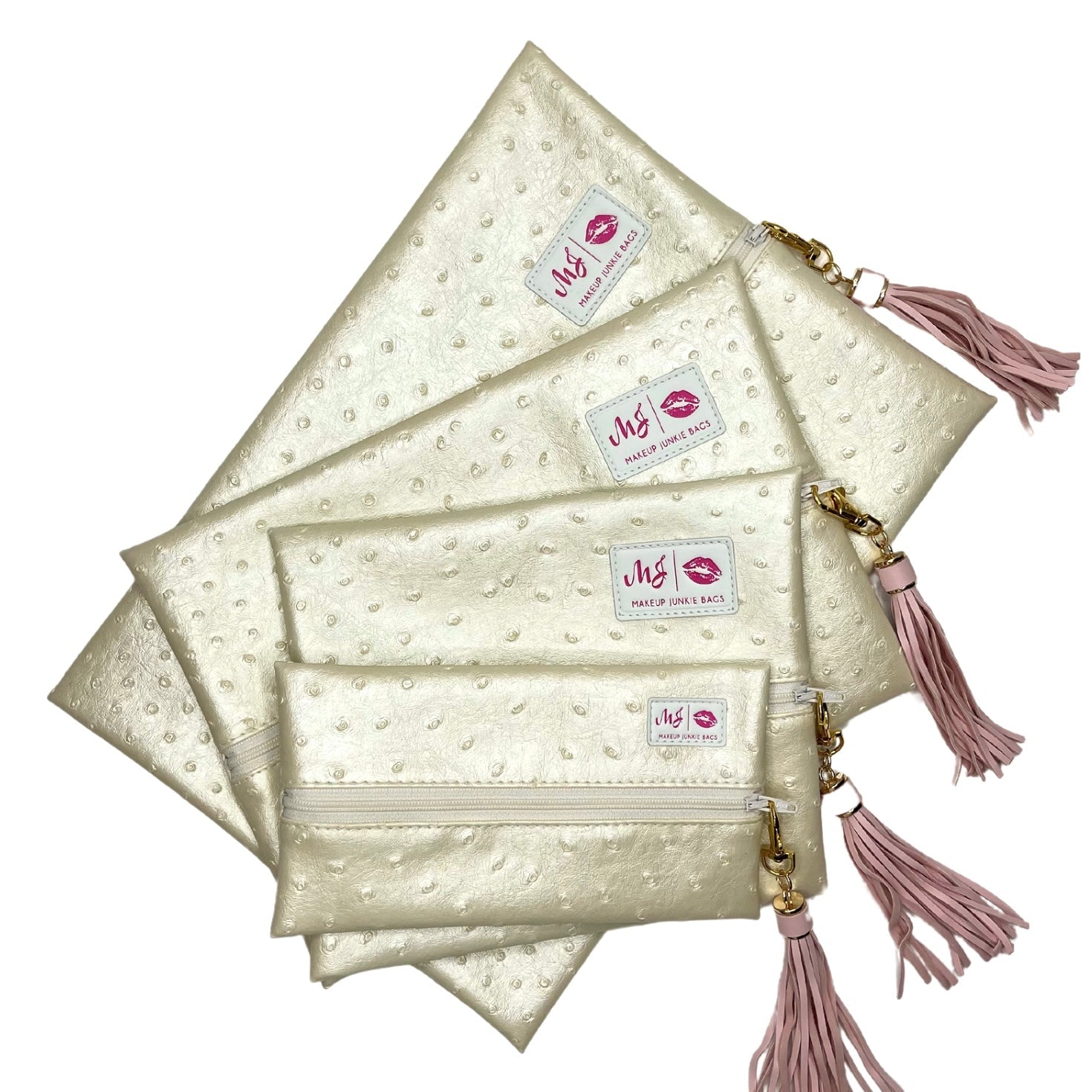 Set of cream-colored pouches with pink tassels and visible brand labels on a white background