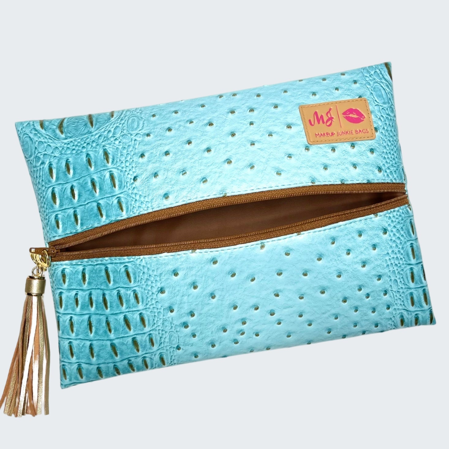 Blue textured clutch bag with a gold zipper and tassel on a white background