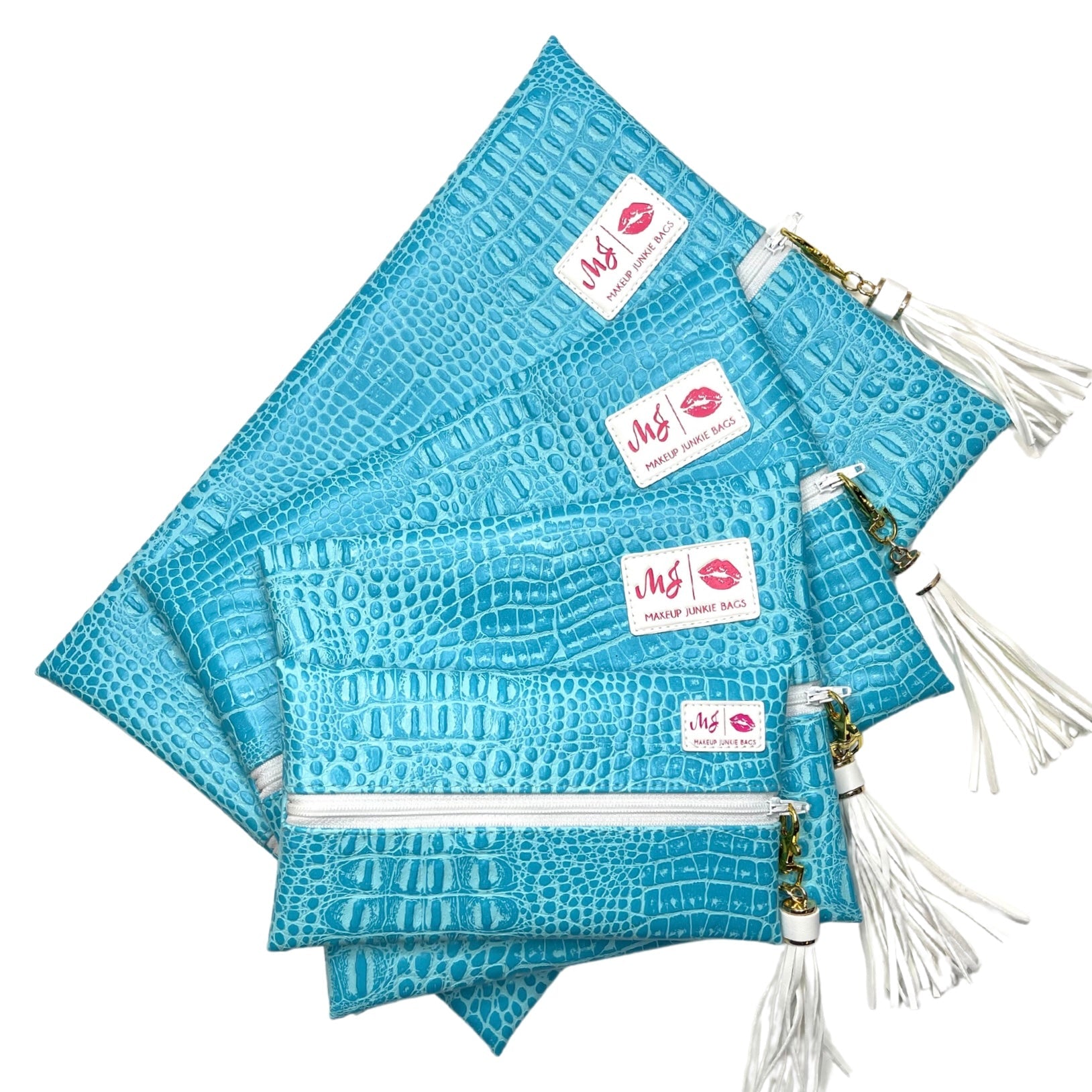 Set of blue textured pouches with white zippers and tassels on a white background