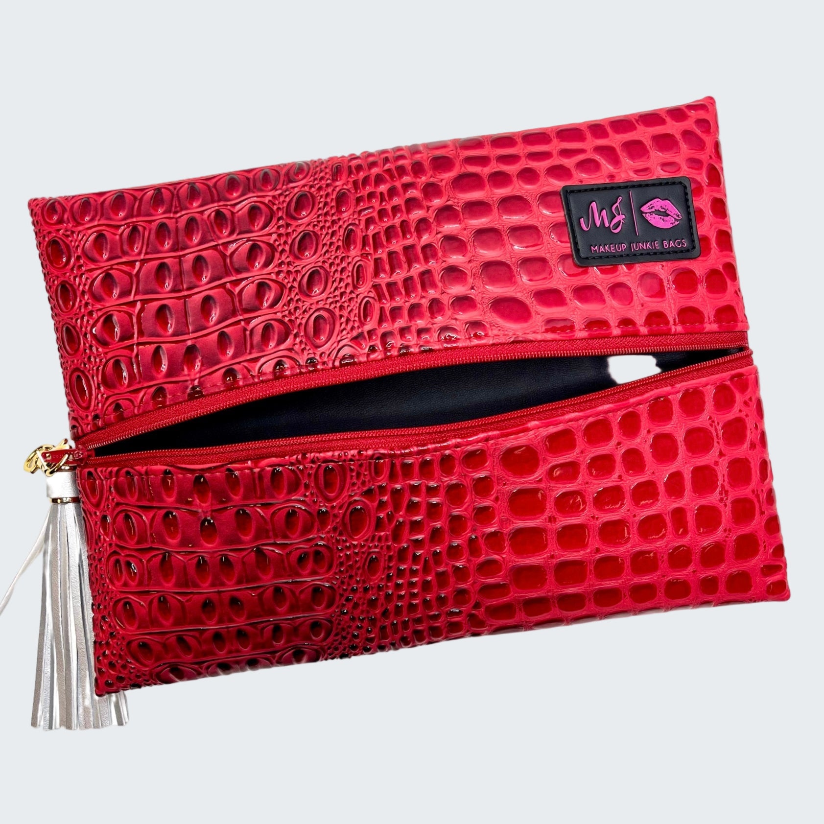 Red textured makeup bag with a visible brand logo on a white background