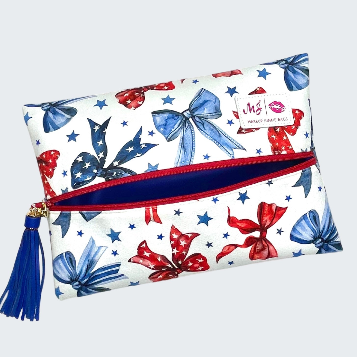 Makeup bag with red, white, and blue bow pattern on a white background