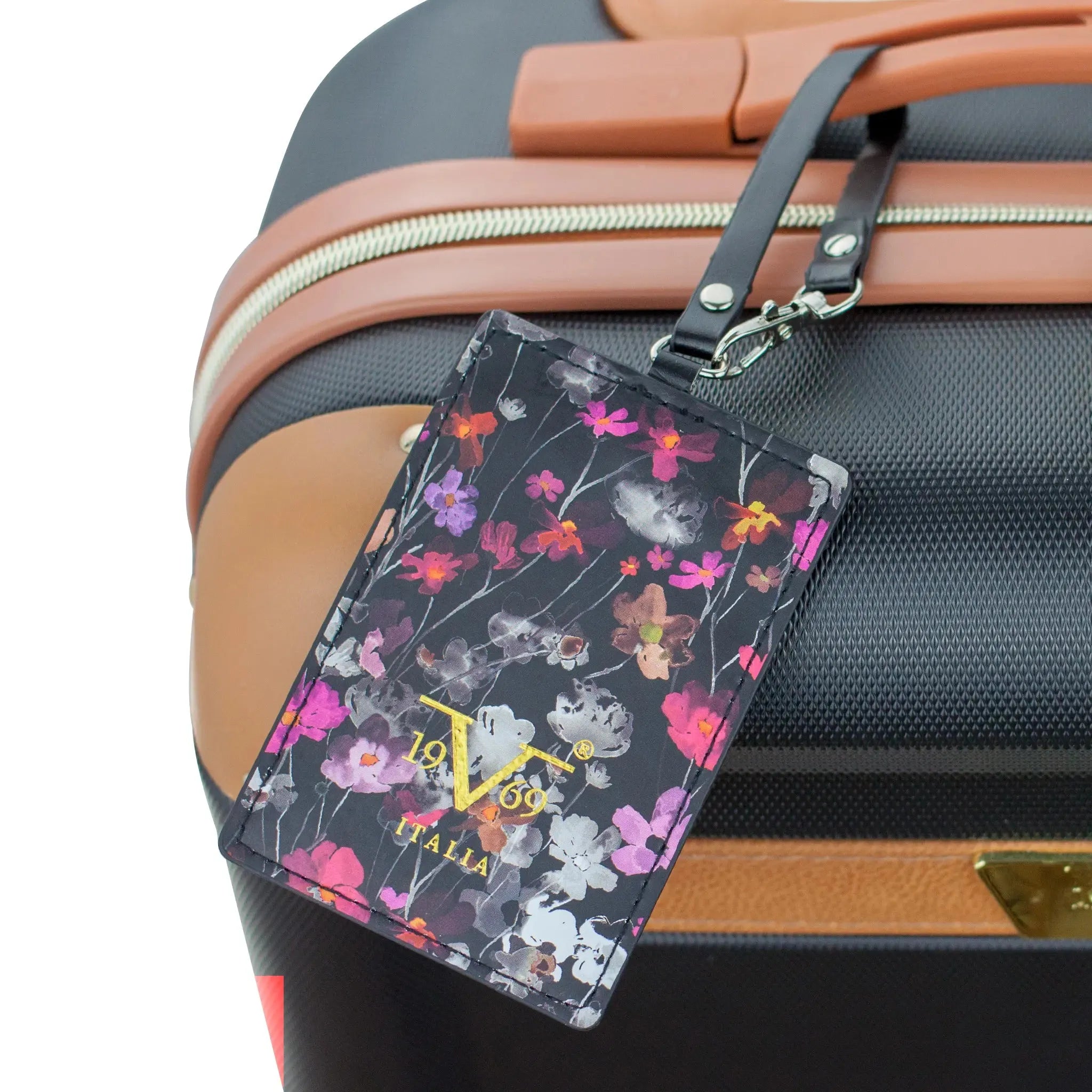 Floral patterned luggage tag attached to a suitcase