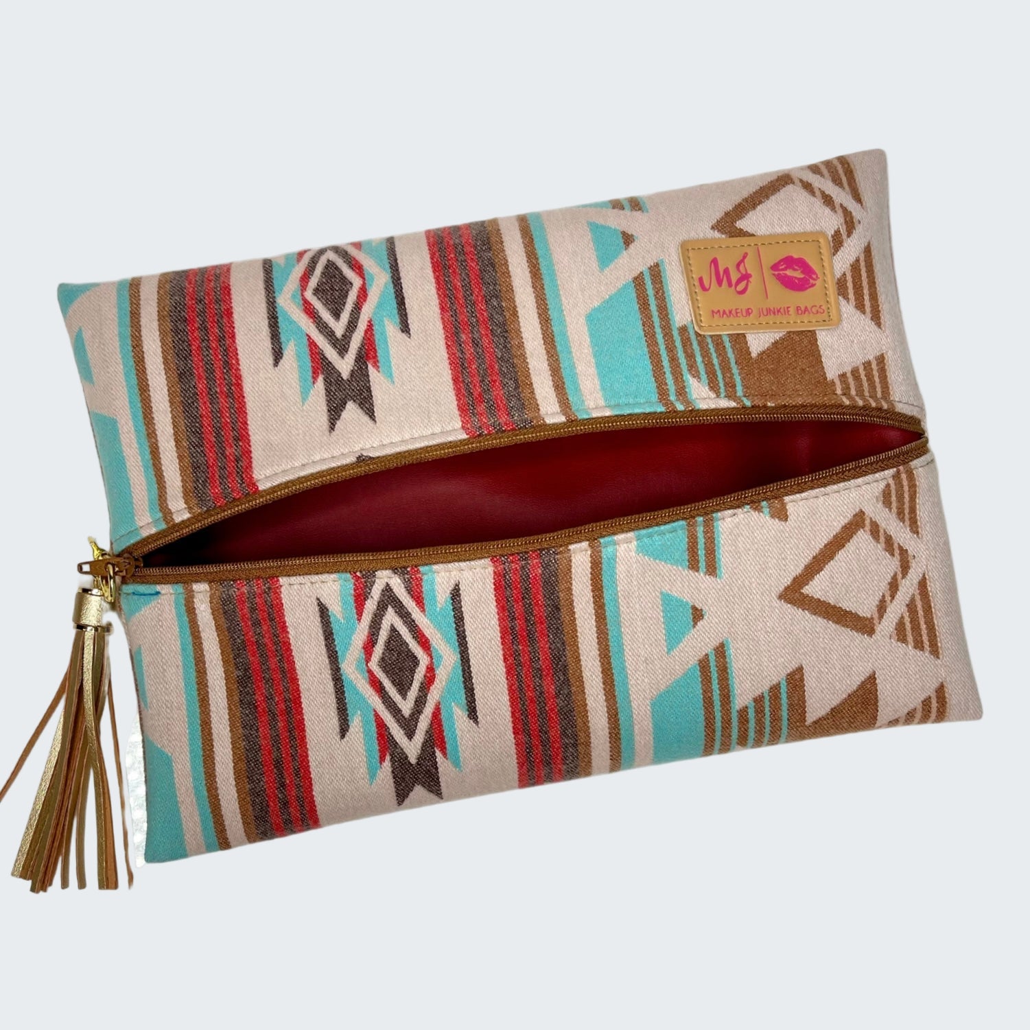 Patterned clutch bag with a tassel on a white background