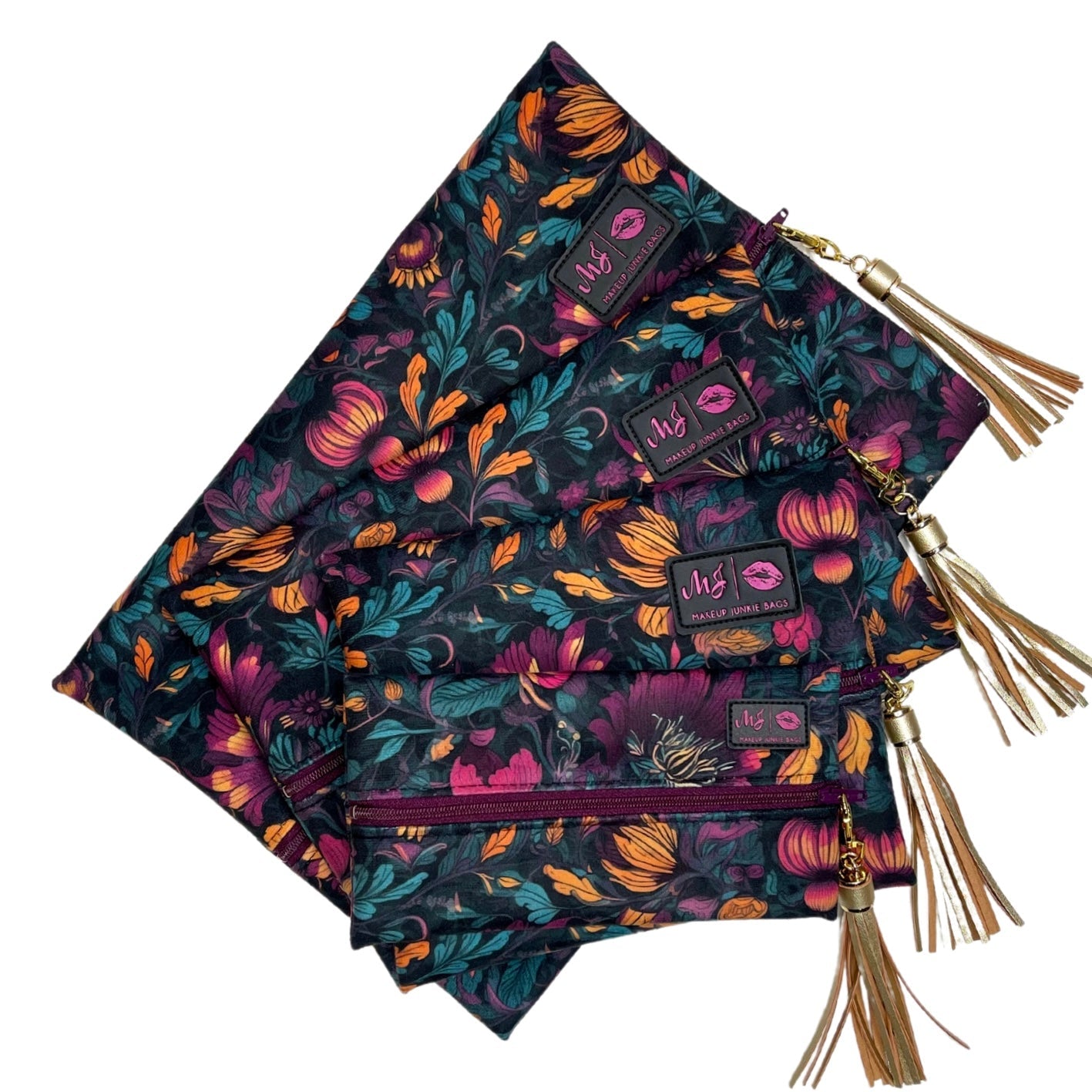 Set of three floral-patterned bags with tassels on a white background