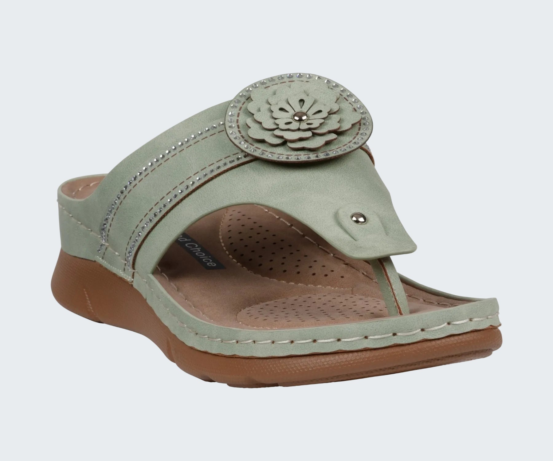 Green sandal with a floral design on a white background