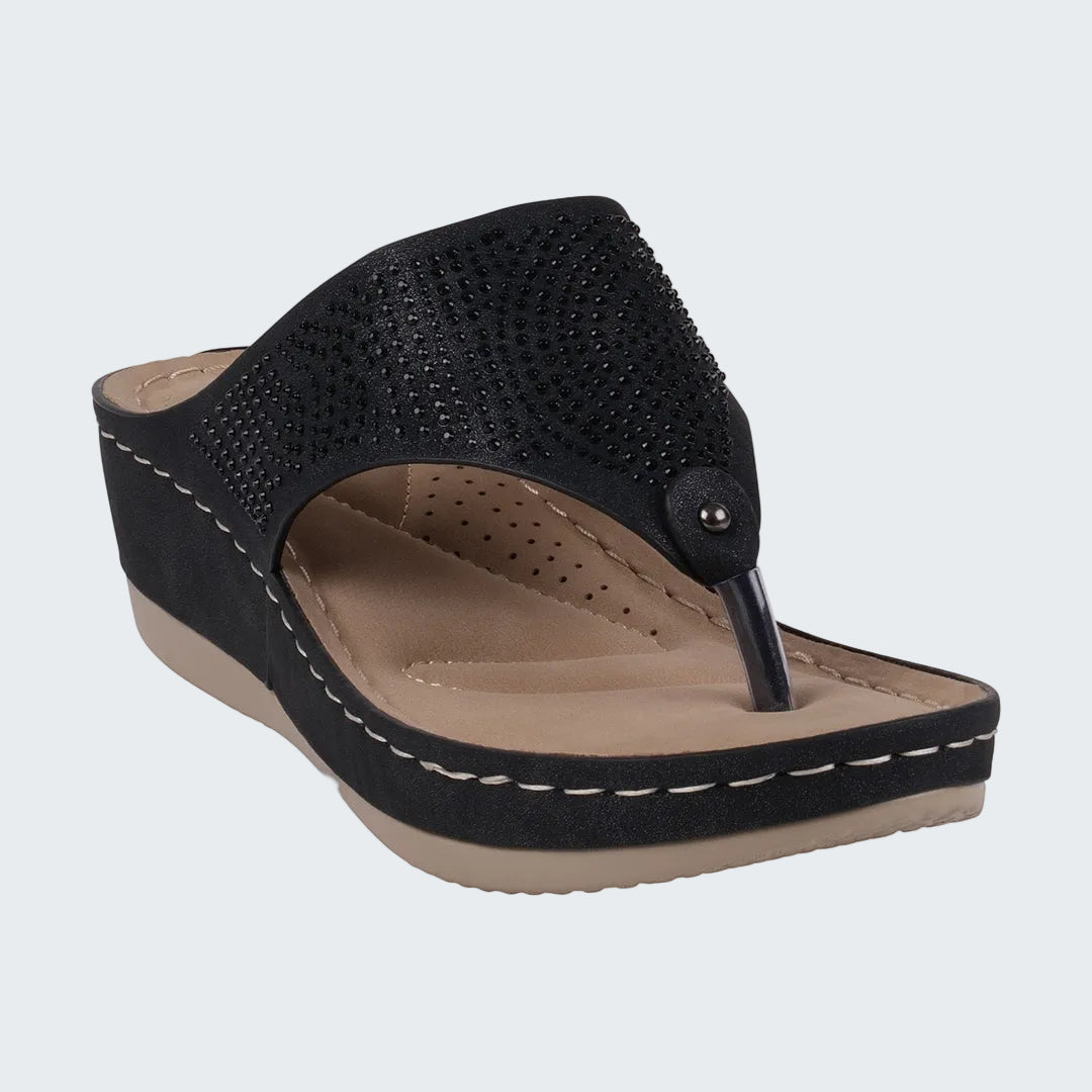 Black wedge sandal with a beige insole on a white background