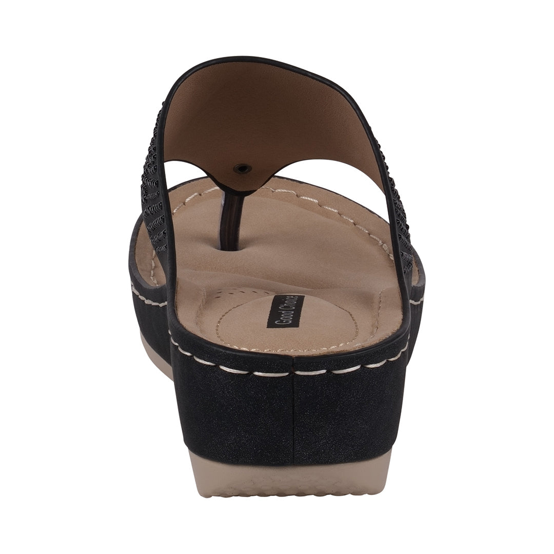 Black sandal with beige sole on a white background