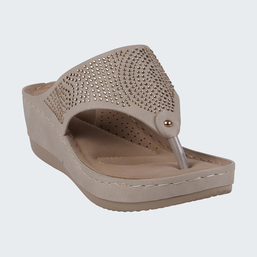 Beige wedge sandal with rhinestone embellishments on a white background