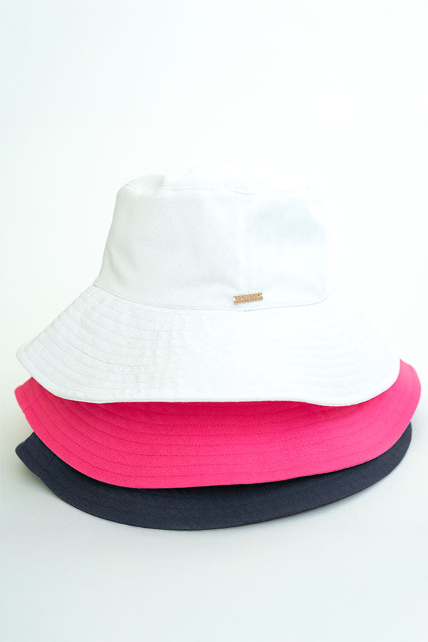 Three colorful bucket hats stacked on a white background