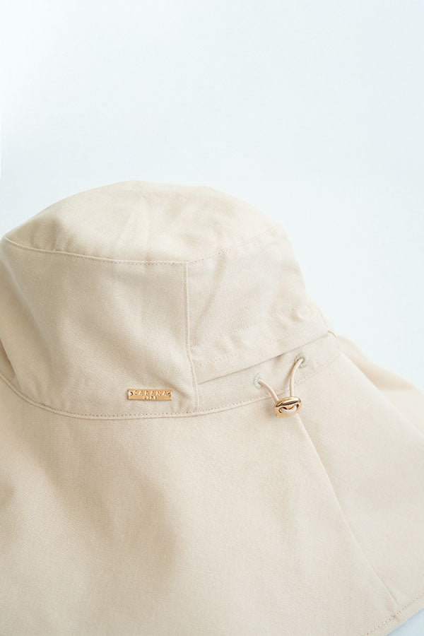 Beige jacket with a brand label on a light blue background