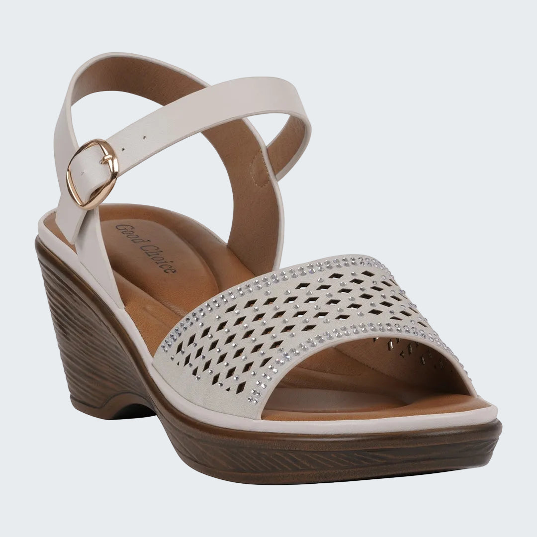 Beige wedge sandal with a strap and heart detail on a white background