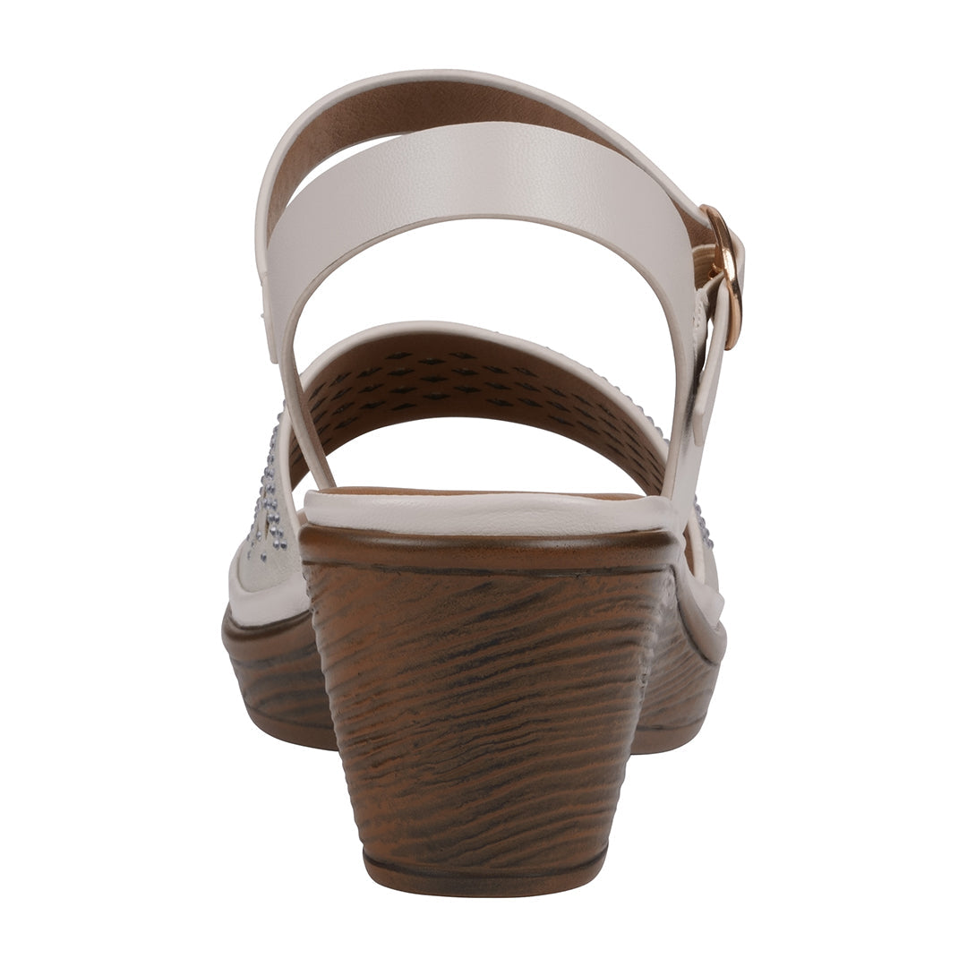 Wedge sandal with white strap and brown sole on a white background