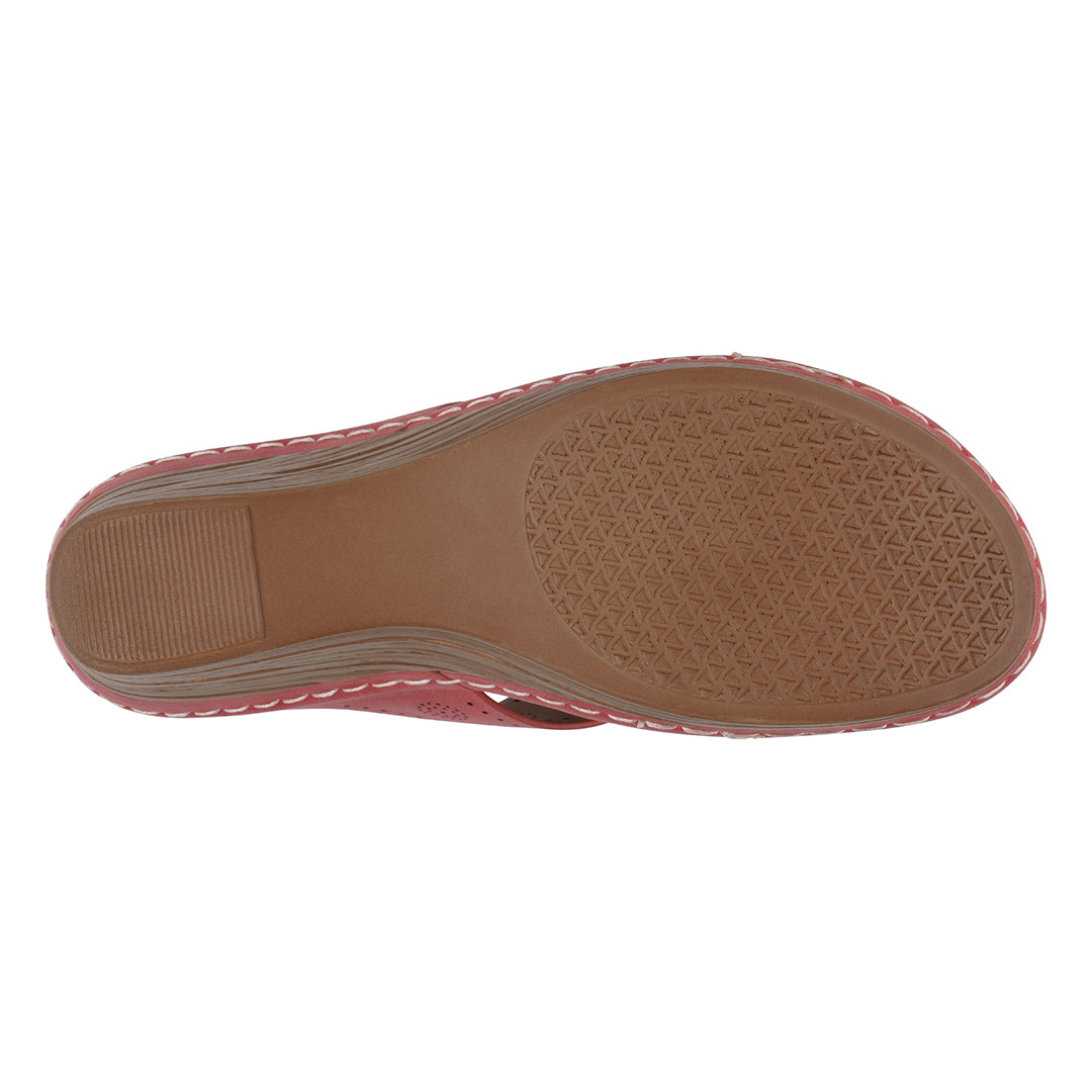 Bottom view of a pink sandal with brown sole on a white background