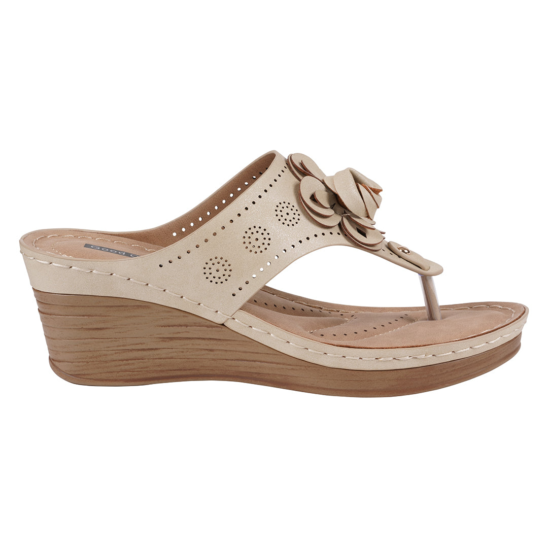 Beige wedge sandal with a floral design on a white background