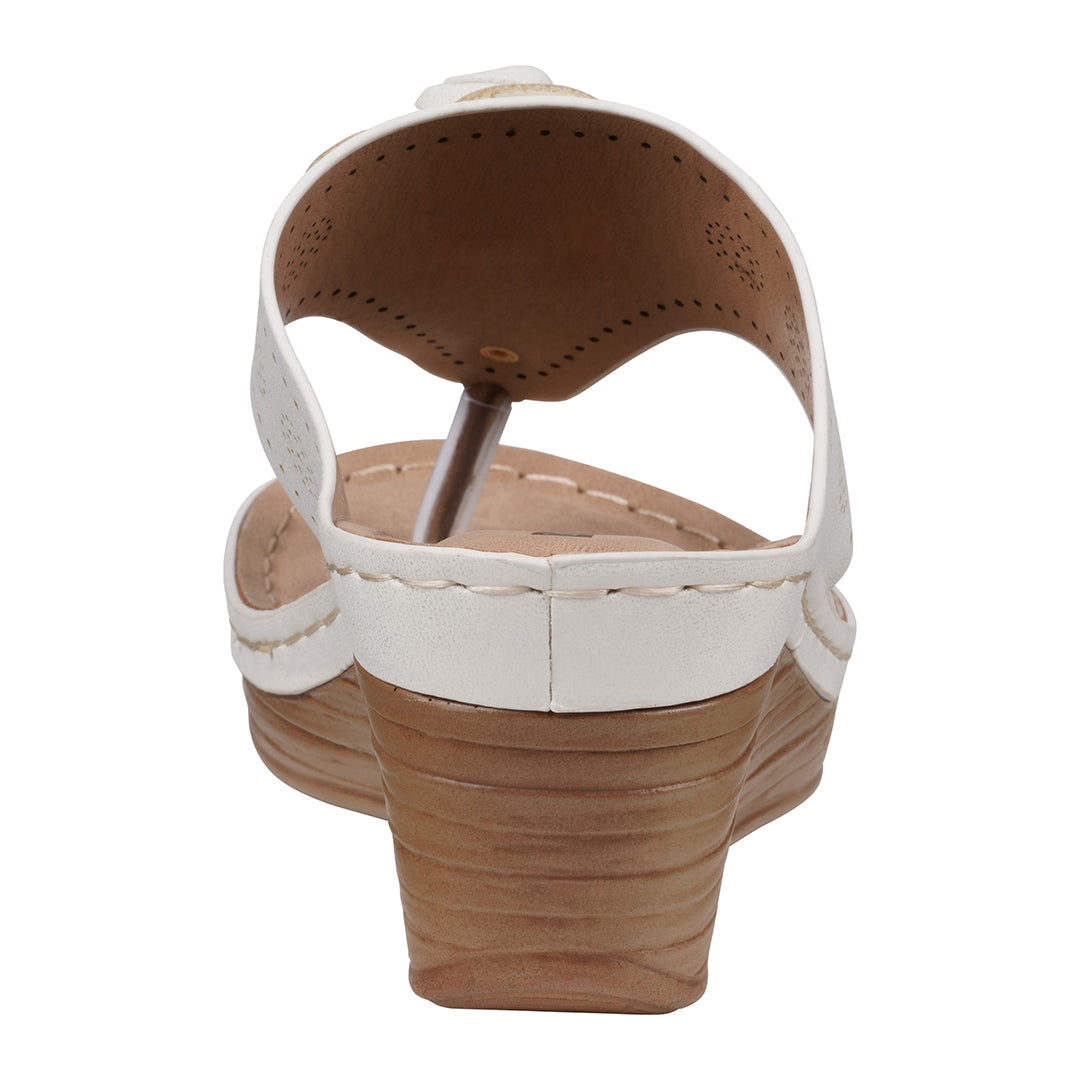 Close-up of a sandal with white strap and brown sole on a white background