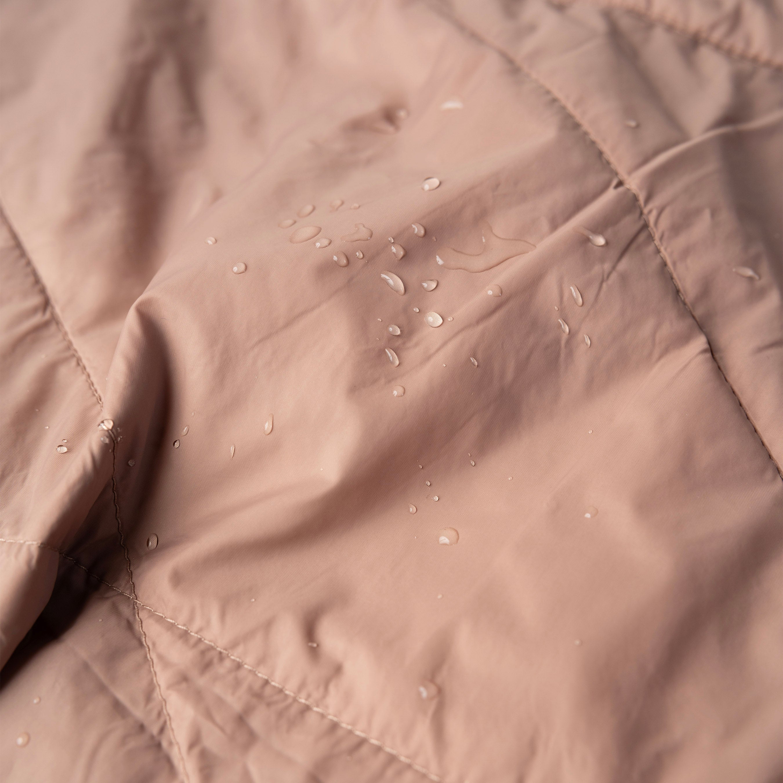 Close-up of a beige fabric with water droplets on it