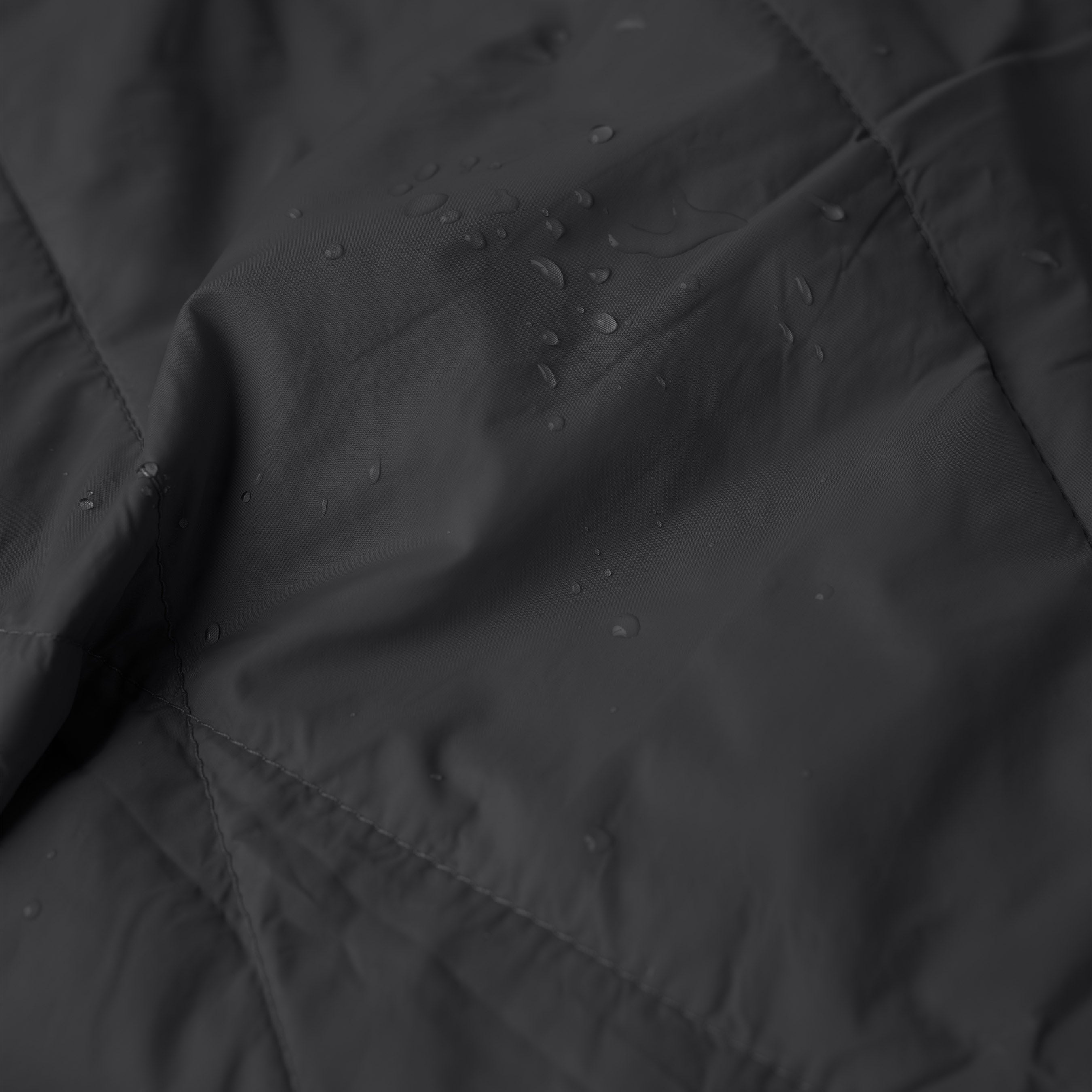 Close-up of a black fabric with water droplets on it