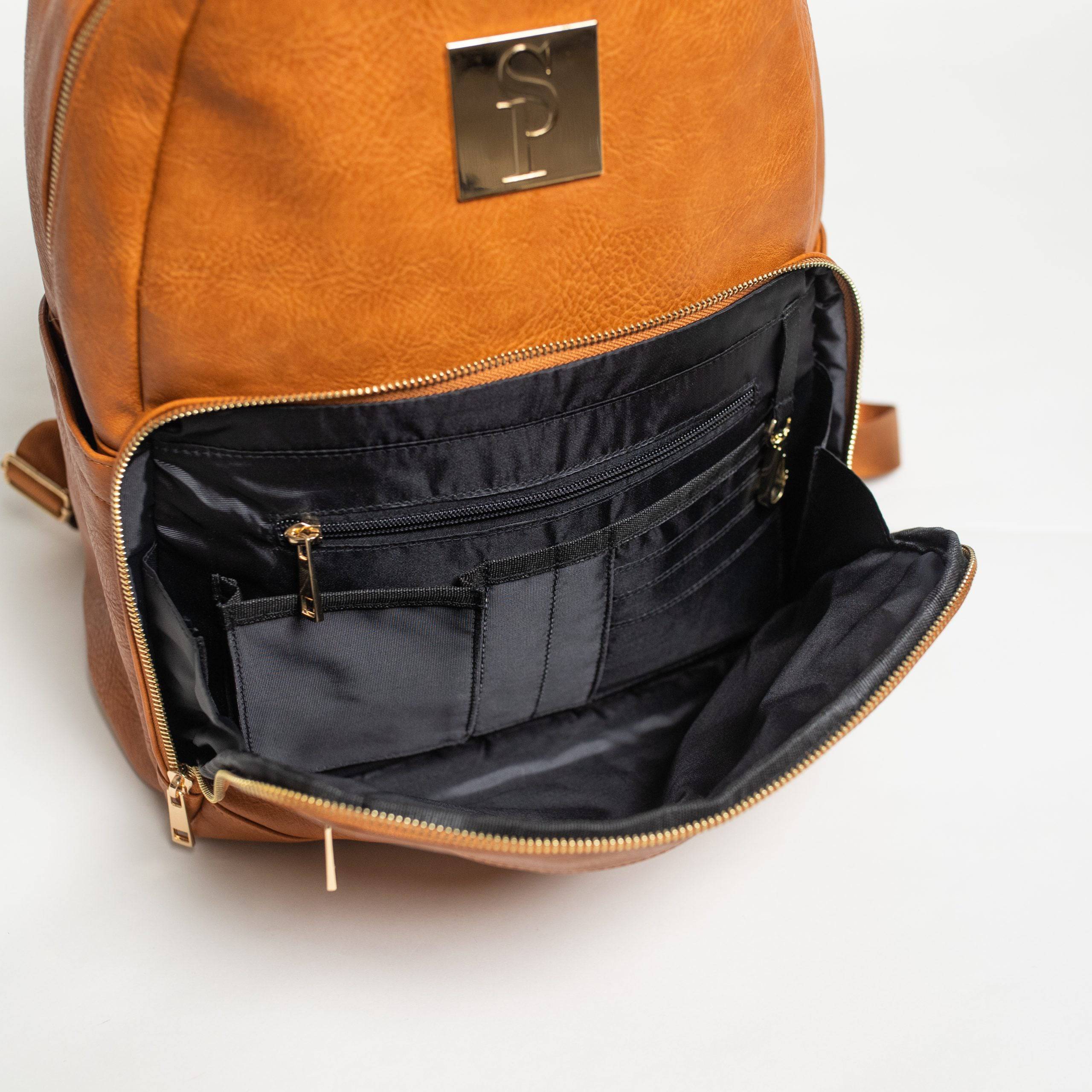 Brown leather backpack with open front compartment on a white background