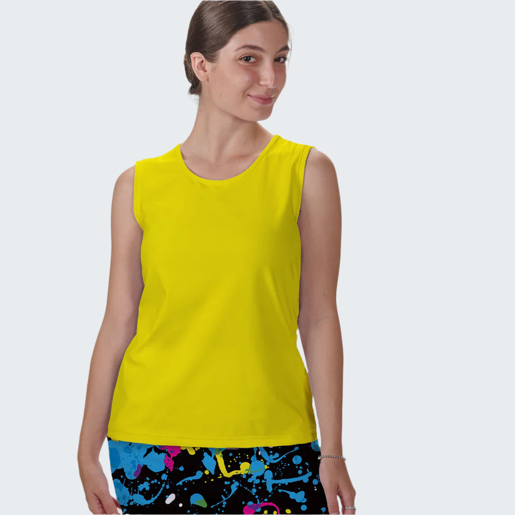 Woman wearing a bright yellow sleeveless top with colorful pants on a white background
