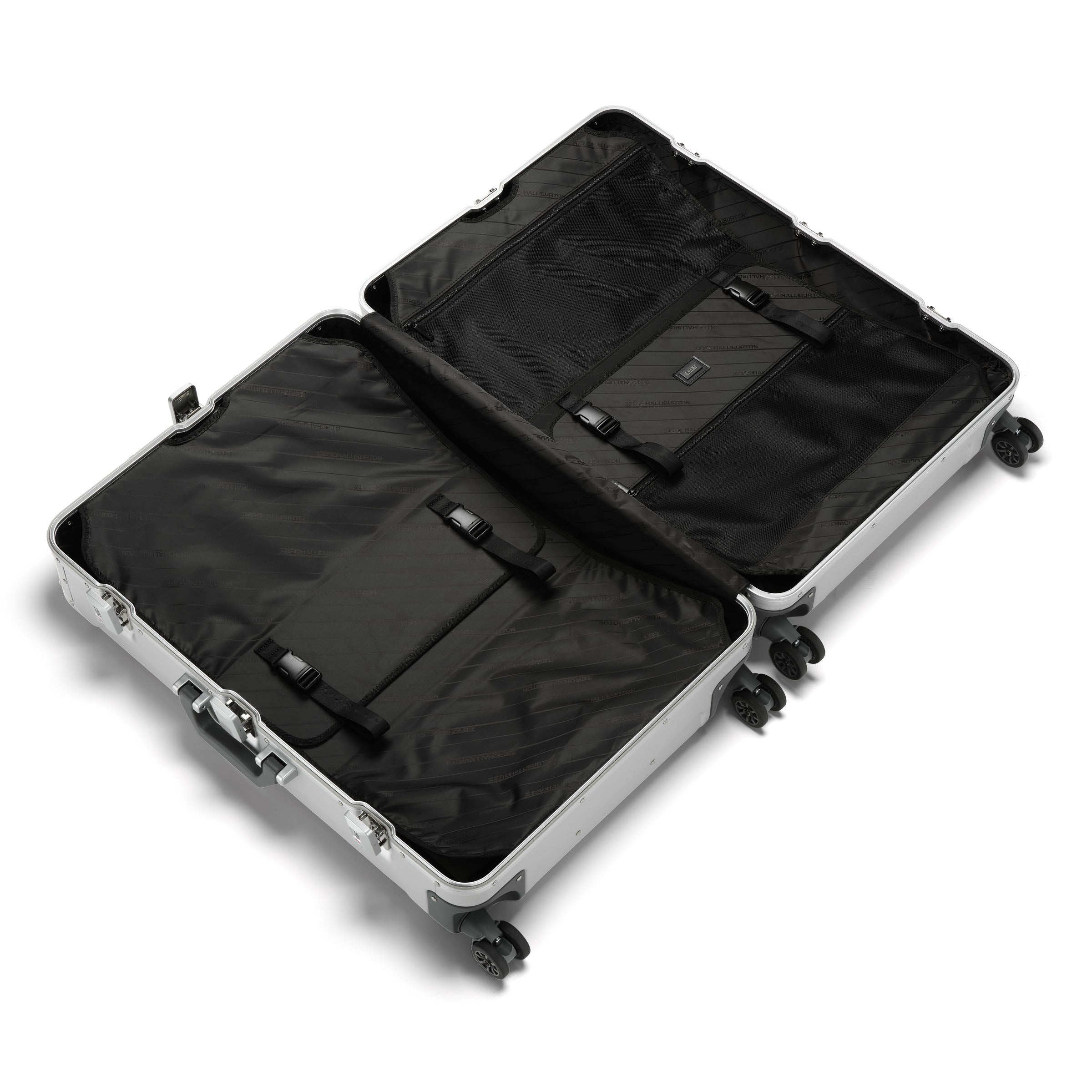 Open silver suitcase with black interior on a white background