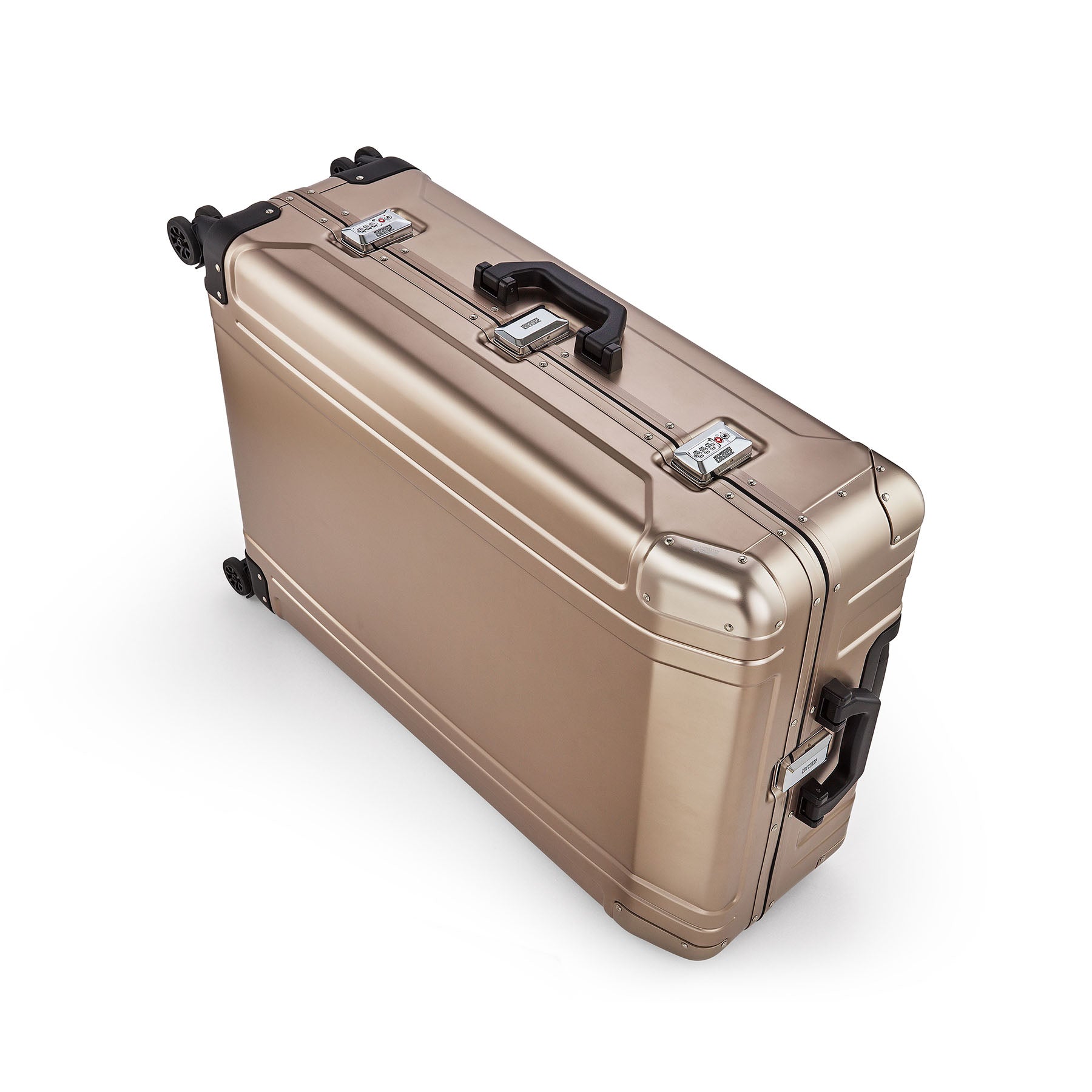 Gold suitcase with black handles and wheels on a white background