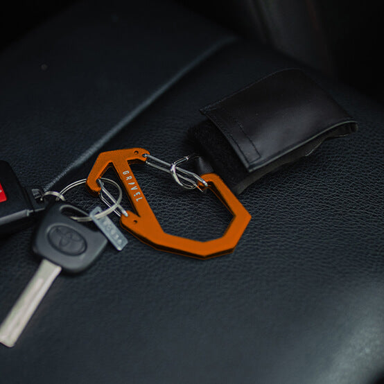 Orange keychain with keys on a car seat