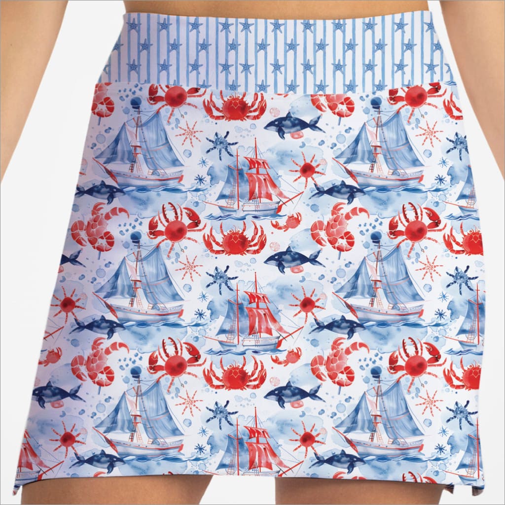 Skirt with nautical pattern featuring ships, crabs, and dolphins on a white background