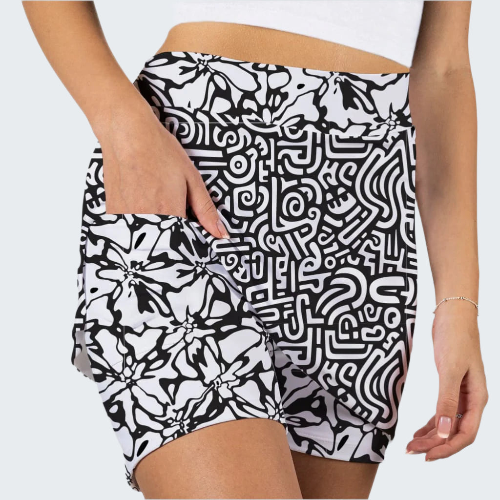 Black and white patterned shorts worn by a person on a plain background