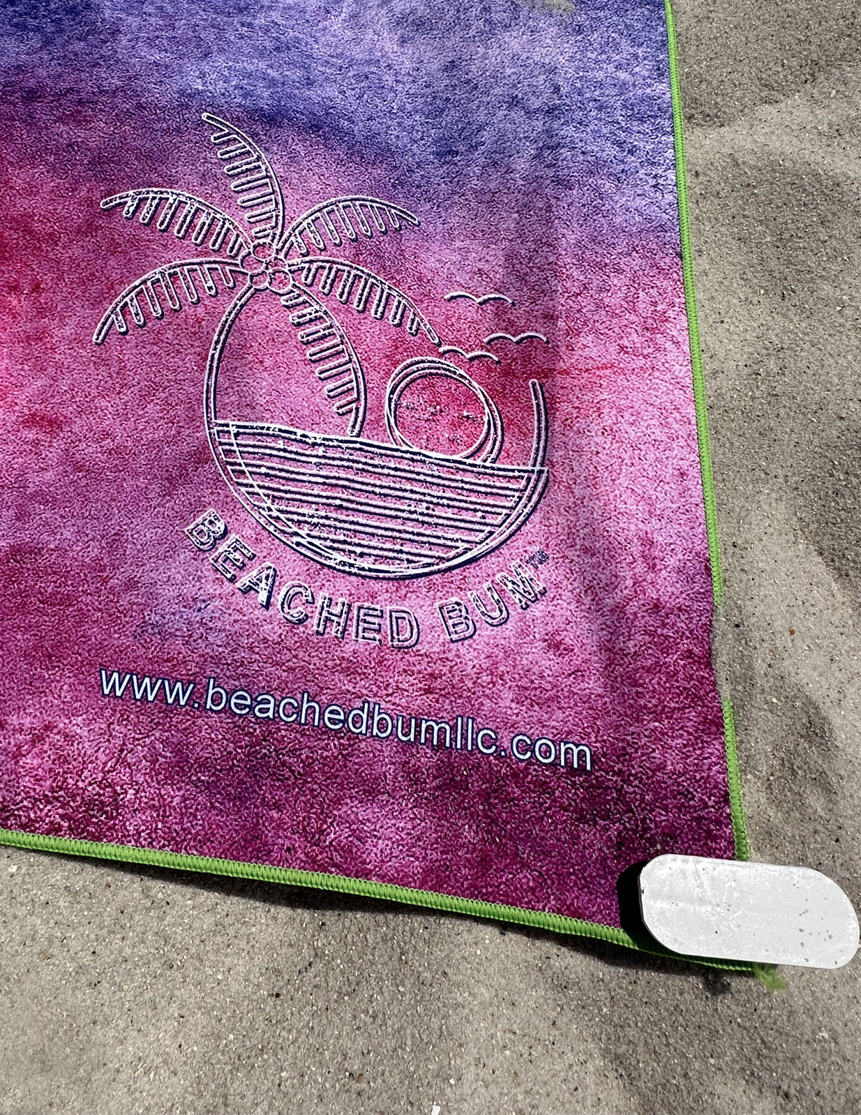 Beached Bum towel with palm tree design on sand