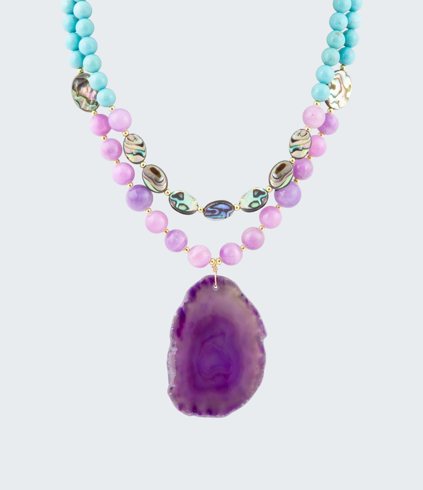 Necklace with purple agate pendant and multicolored beads on a white background