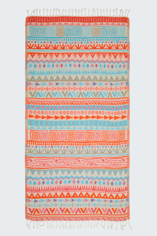 Colorful patterned towel with fringes on a white background