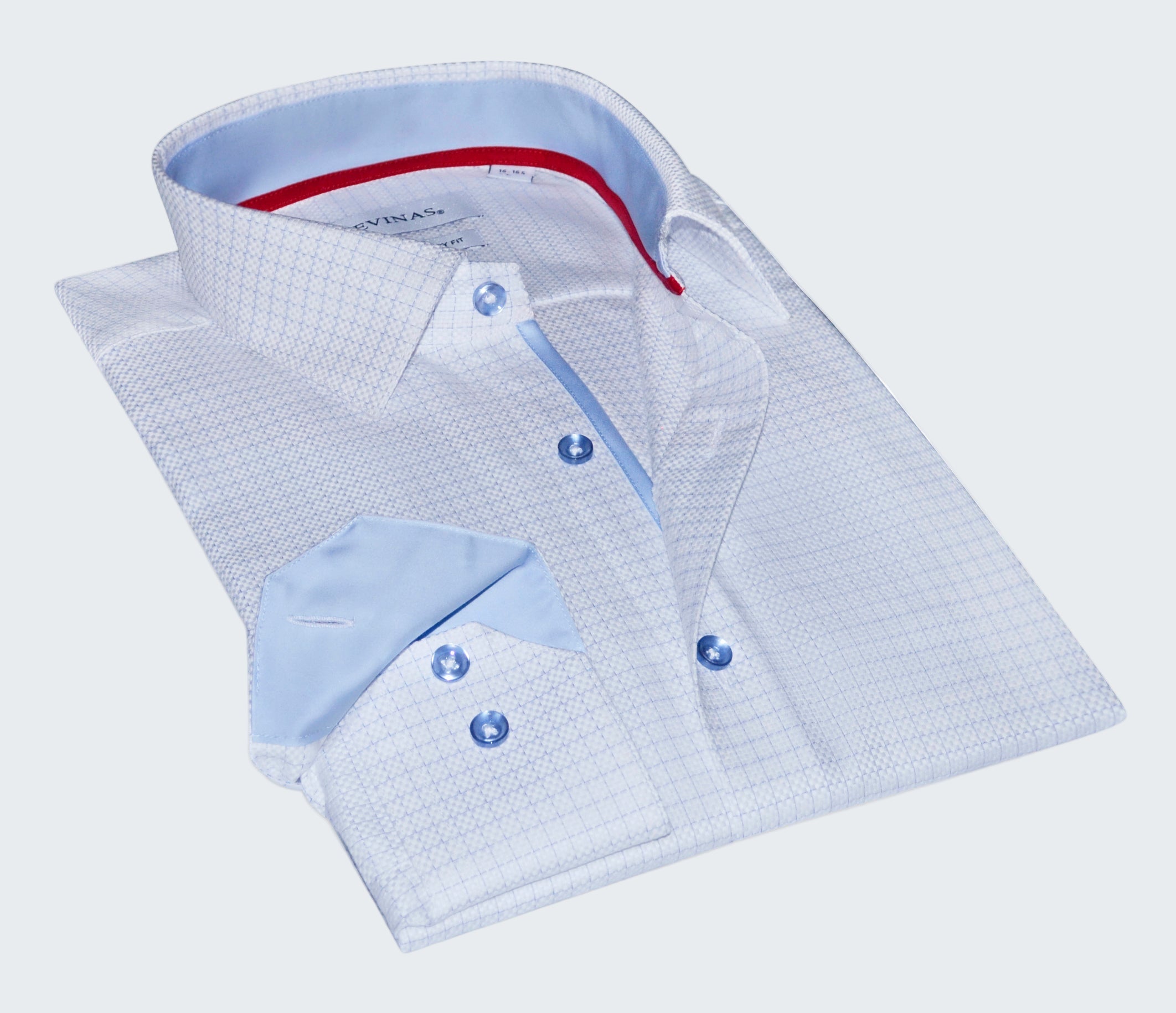 Folded light blue checkered shirt with red lining on a white background
