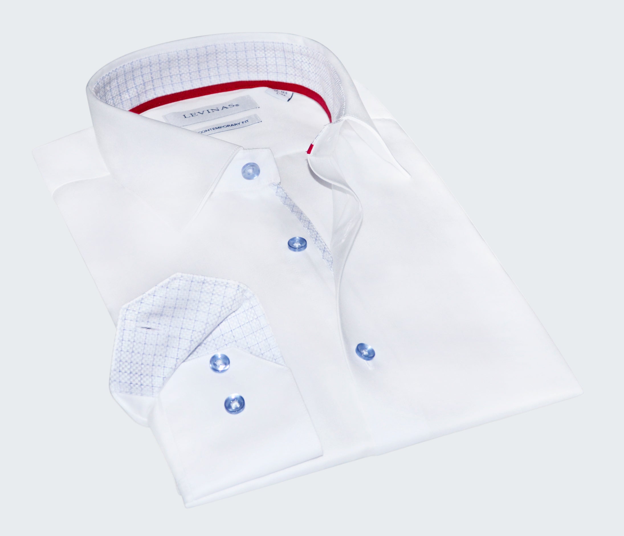 Folded white dress shirt with blue buttons on a white background