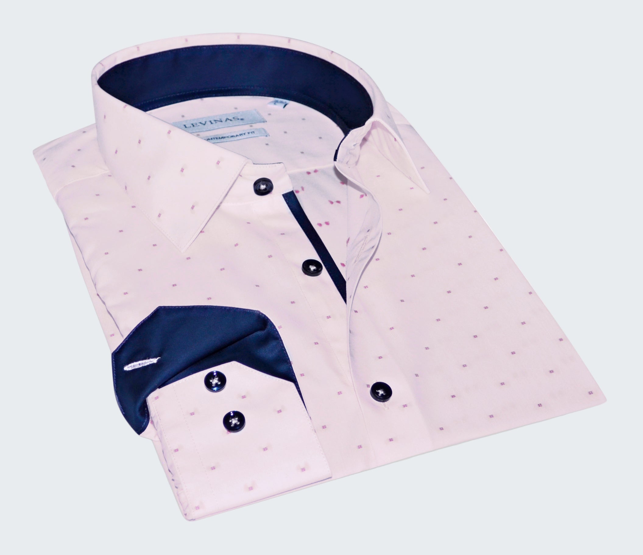Pink dress shirt with white pattern and blue collar on a white background