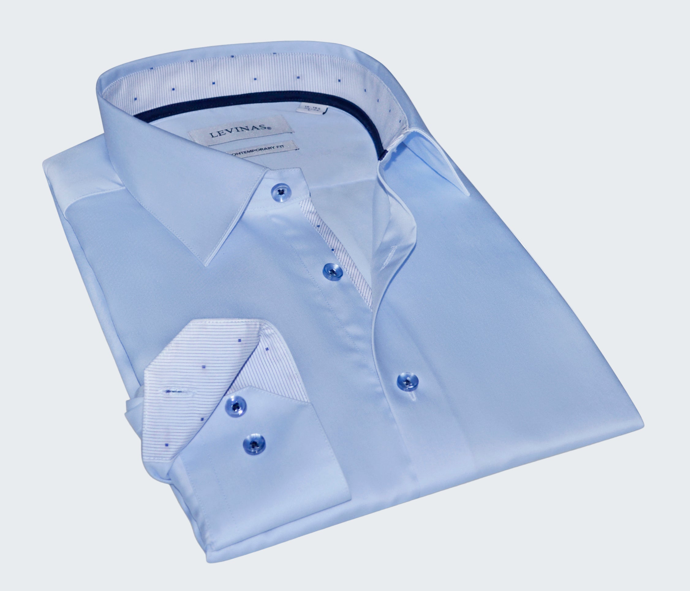 Folded light blue dress shirt with collar and cuffs on a white background