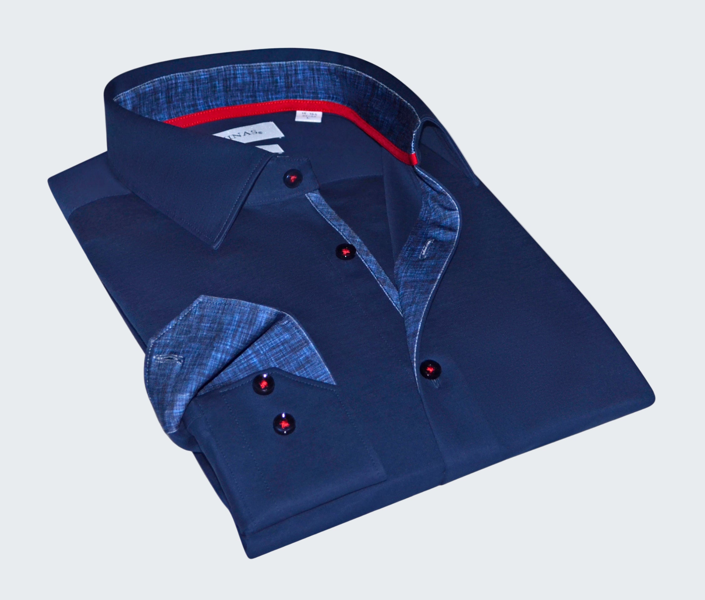 Folded blue shirt with red buttons on a white background