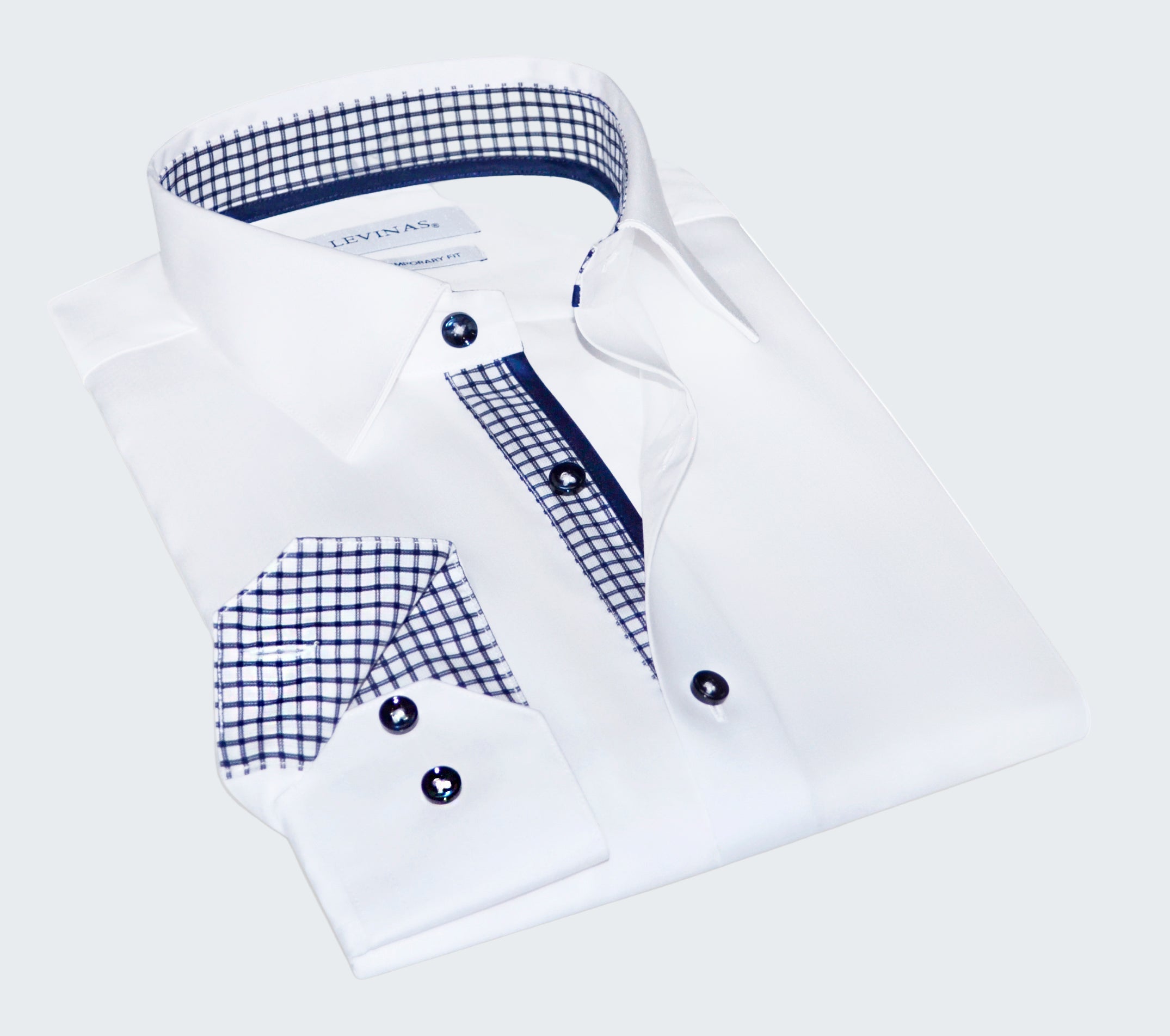 Folded white dress shirt with blue plaid accents on a white background