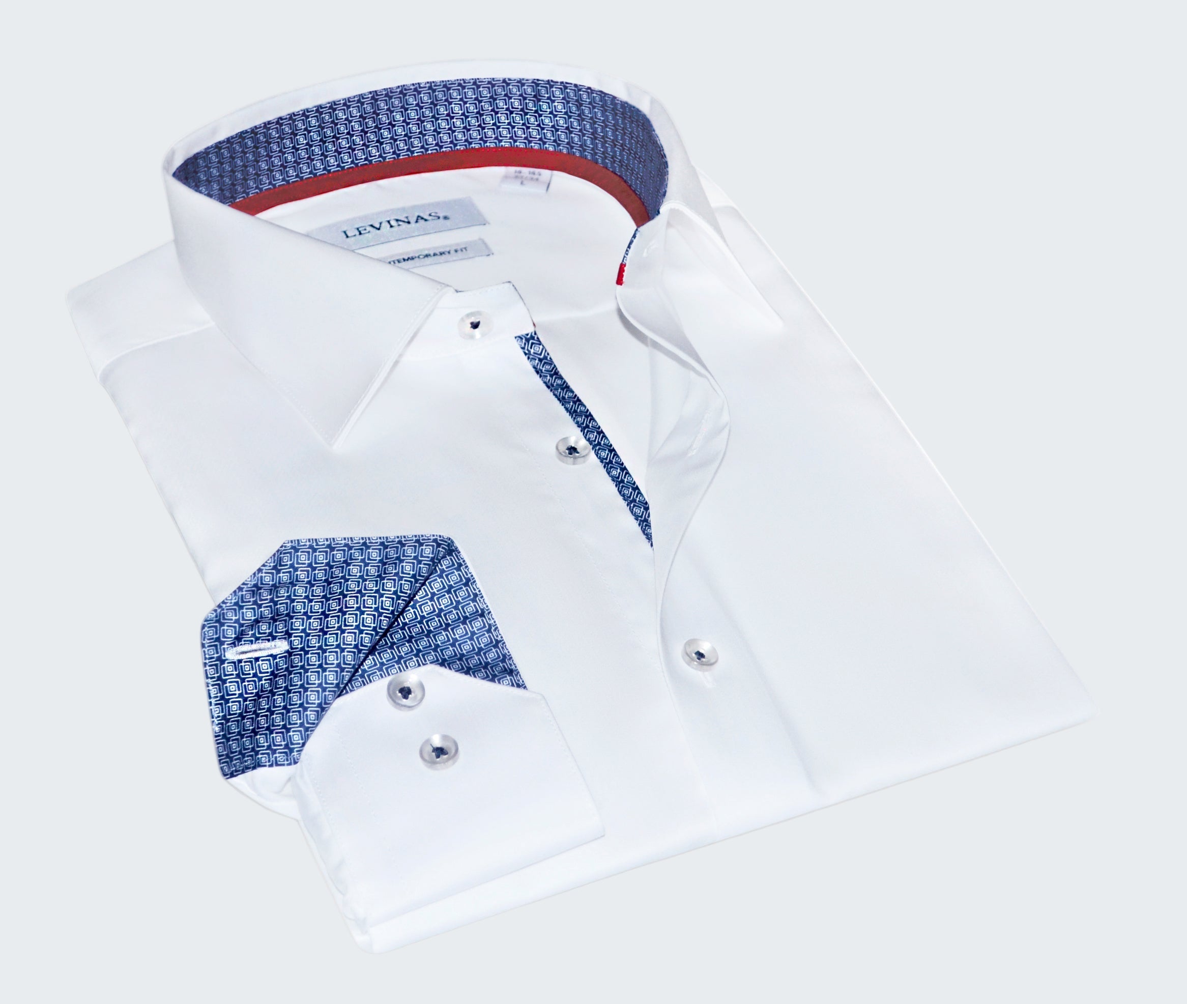 Folded white dress shirt with blue and red interior details on a white background