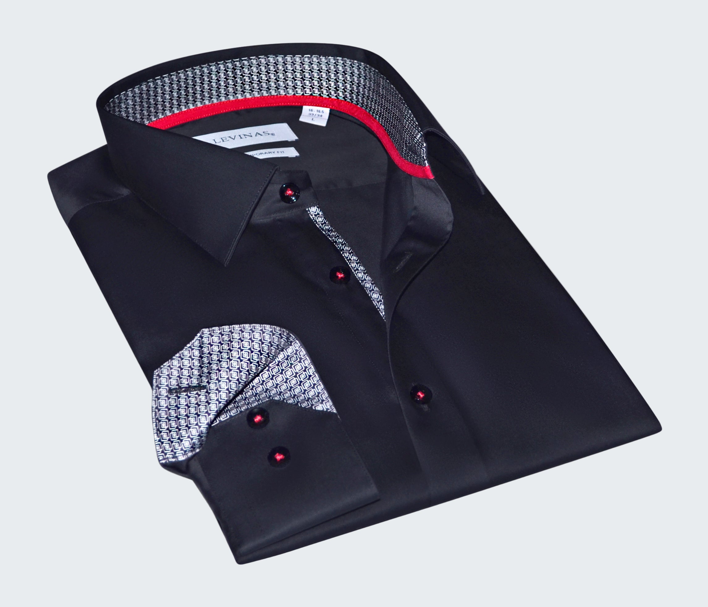 Folded black dress shirt with patterned collar and cuffs on a white background