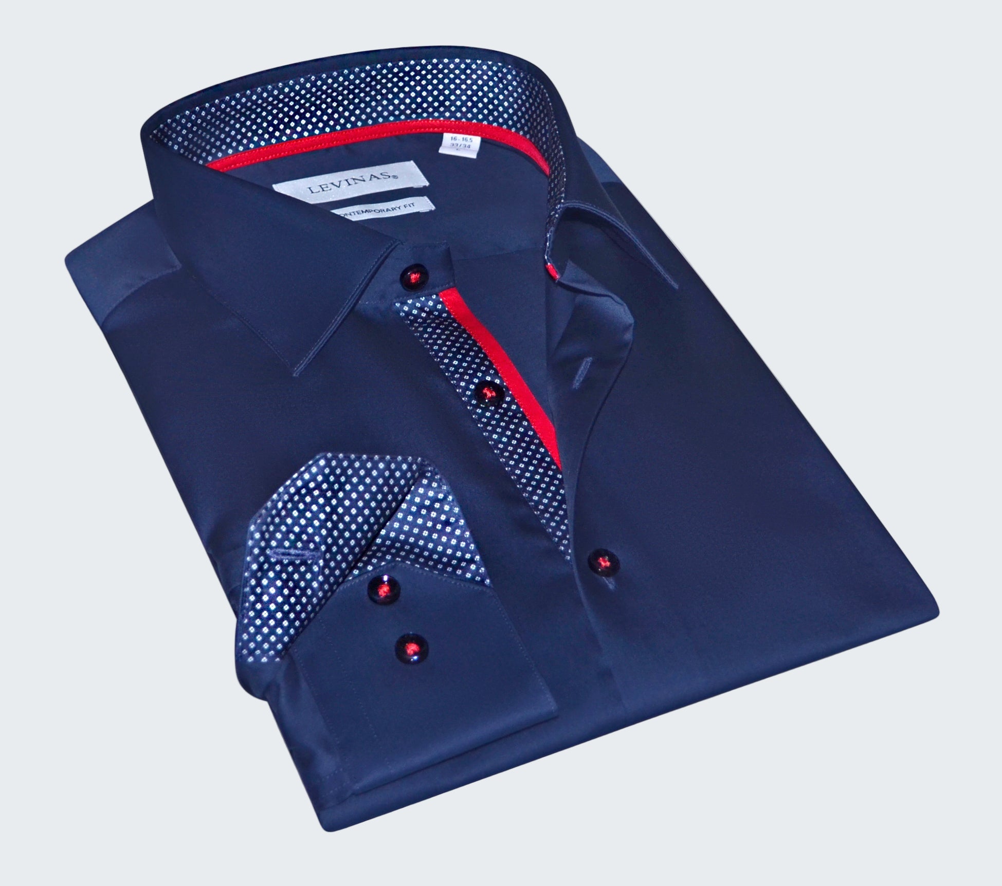 Folded blue dress shirt with red accents on a white background