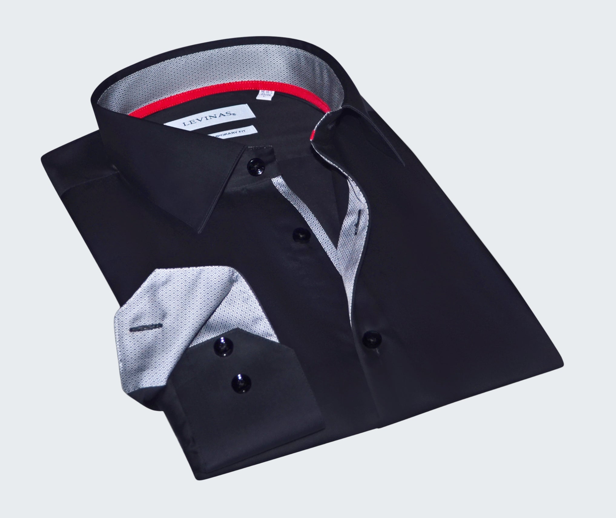 Folded black dress shirt with a gray interior on a white background